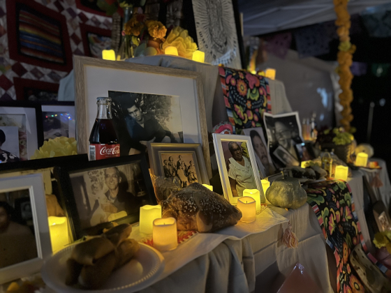 pictures, candles, and other items on an ofrenda