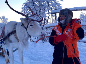 Michaela Stith standing next to reindeer