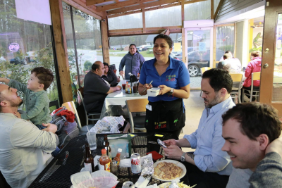 photograph of a group of people eating in a restaurant